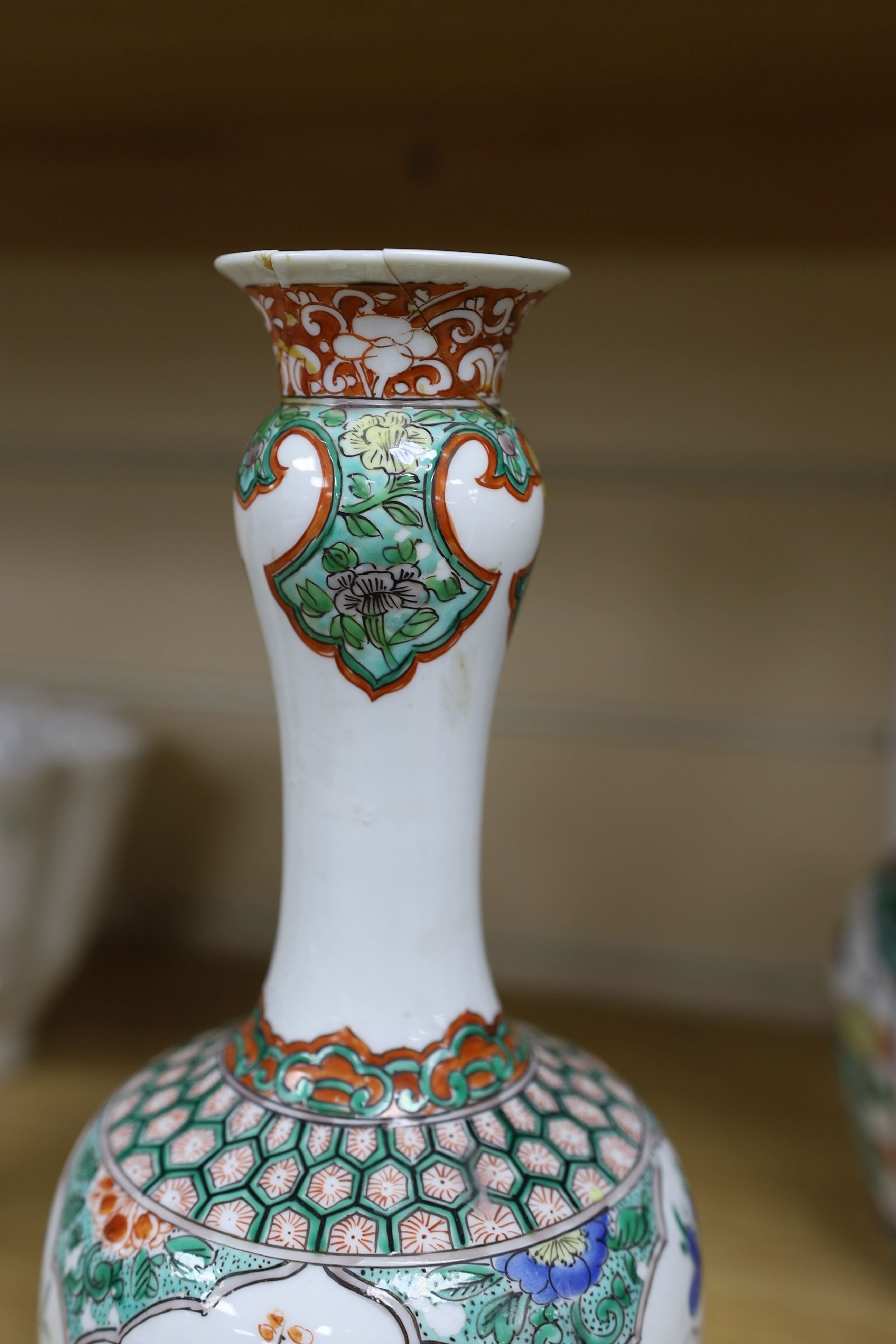 A pair Samson of Paris vases in the Chinese famille verte style and a Chinese Qianlong famille rose garlic neck vase with blue panelling motif, tallest 26cm